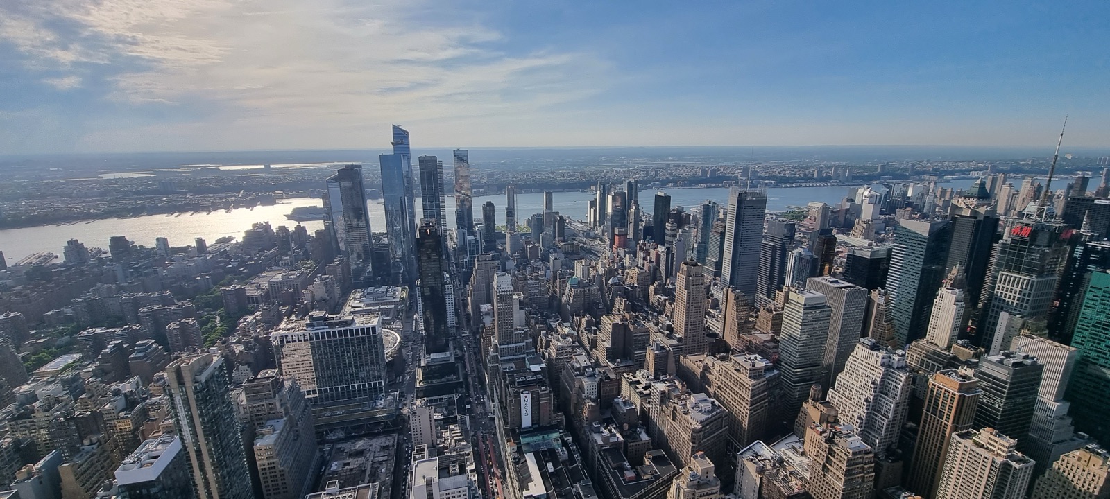 Central Park seen from the Empire State Building as a long green rectangle cutting through the dense gray grid of Manhattan, with the reservoir showing in the middle