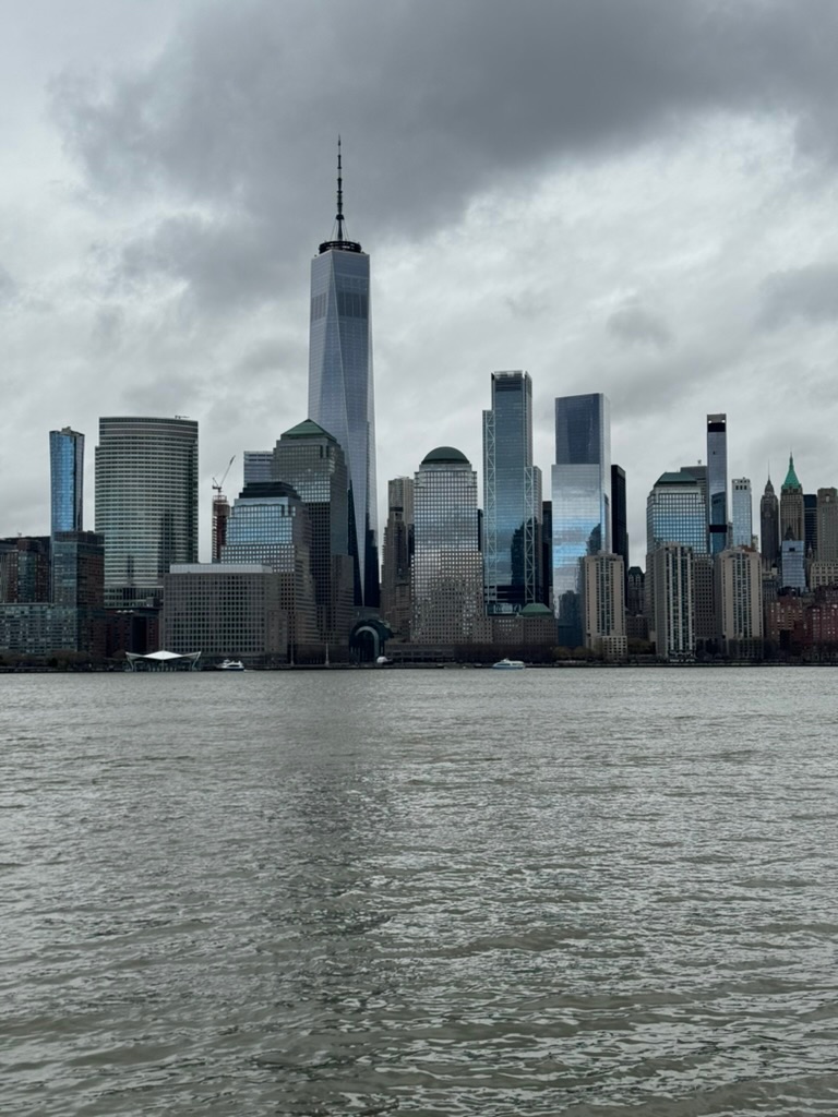 Lower Manhattan skyline under heavy overcast, the towers muted grey